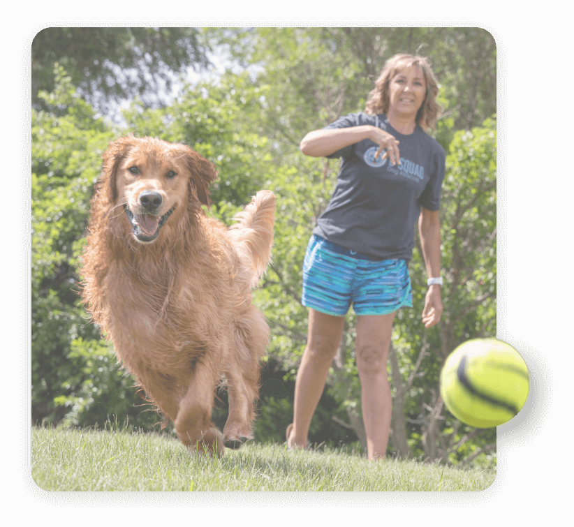 Woman playing fetch with a dog